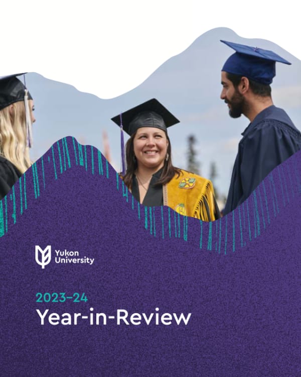 Three students in grad regalia in conversation outdoors