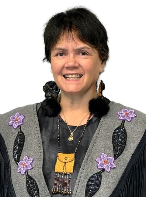 Brenda Butterworth-Carr, wearing beaded earrings and vest