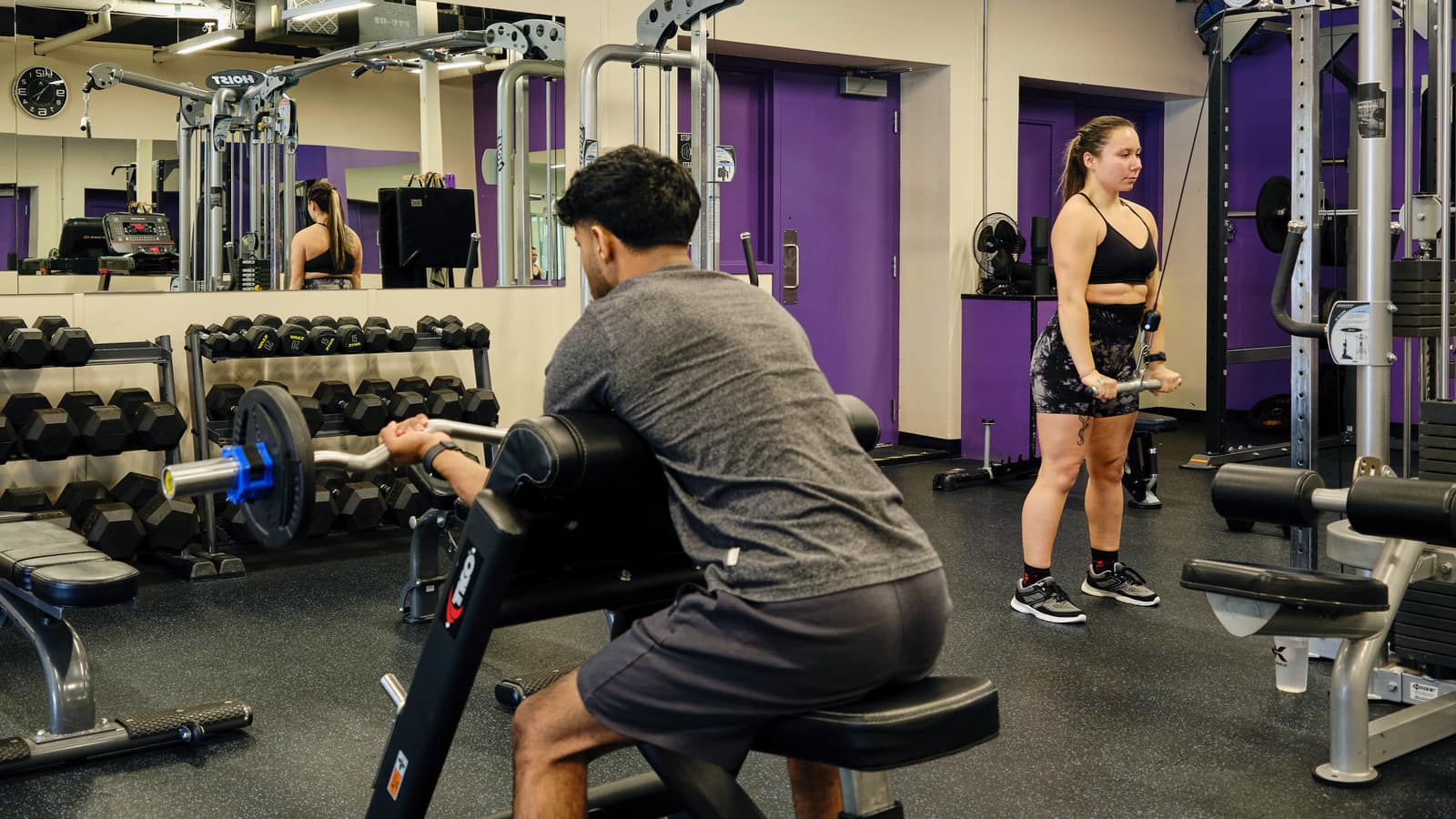 Two students working out in the Yukon University gym.