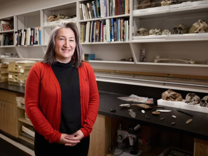 Victoria Castillo posing in front of a book shelf in a lab