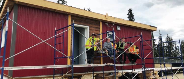 Building Stability students in front of the tiny house they have built