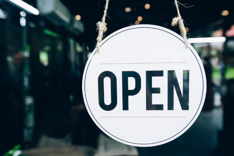 "Open" sign hanging in a window