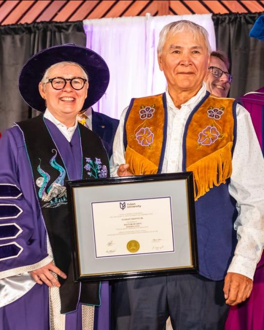 Stanley Njootli receiving a framed degree parchment from Dr. Lesley Brown and Dr. Ernie Prokopchuk
