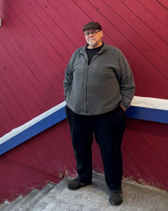 man standing in front of YukonU Faro campus sign